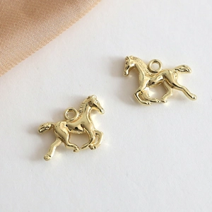 Close-up of golden unicorn pony alloy pendants for DIY jewelry making accessories