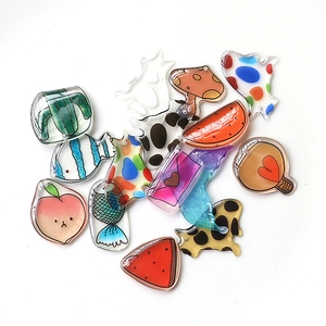 Macro detail of translucent acrylic DIY charms in various cute fruit and plant shapes
