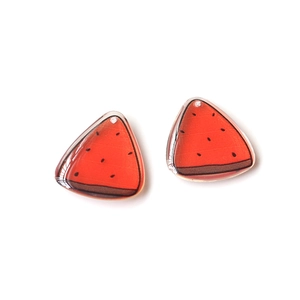 Macro shot of translucent watermelon resin charm with pre-drilled hole for DIY jewelry