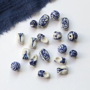 Macro view of assorted blue and white porcelain beads with traditional Dutch patterns
