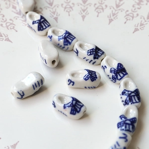 Macro view of blue and white porcelain windmill clog beads for DIY jewelry making