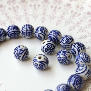 Macro shot of blue and white porcelain ceramic beads with traditional Chinese patterns