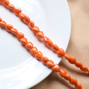 Polished bright orange 3D heart-shaped ceramic beads for DIY handmade jewelry crafting