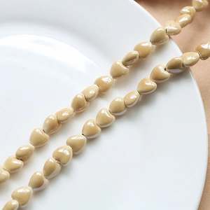 DIY beige heart-shaped ceramic beads for jewelry making with glossy finish