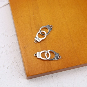 Detail of vintage silver handcuff pendants engraved with Freedom for jewelry making