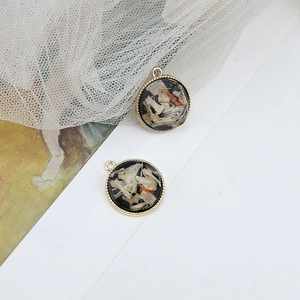 Detail of round gold bezel charms featuring embedded dried flowers for DIY jewelry making