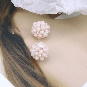 Macro view of pink AB crystal beaded ball earrings with faux pearls and sequins