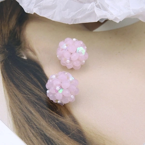 Macro shot of pink beaded sphere earrings with AB crystal petals and mini white pearls