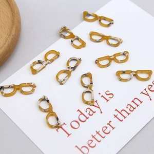Detailed macro of tortoise shell acetate mini eyeglass pendants for DIY jewelry making