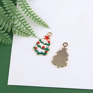 Front and back detail of DIY enamel Christmas tree charms with green snow and gold plating