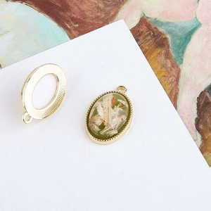 Detailed macro view of vintage oval shell pendant DIY earring accessory with gold bead edging