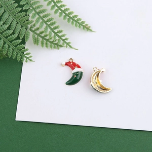 Detailed macro view of a Christmas moon alloy charm with red hat and gold stars