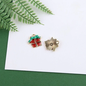 Detailed view of enamel Christmas gift box charms with red green festive finish