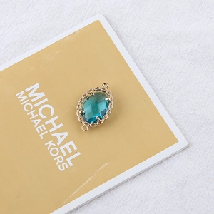 Detailed view of gold plated leaf pendant with blue zircon for DIY jewelry making