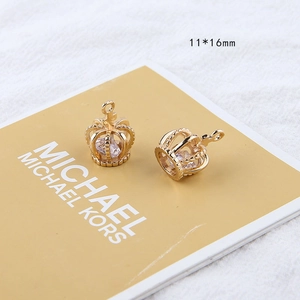 Detail view of 18K gold plated crown pendants with zircon inlays and 11x16mm size