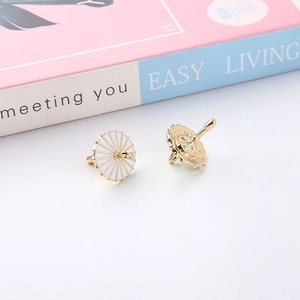 Macro detail of gold-plated alloy enamel umbrella charms for DIY earring accessories