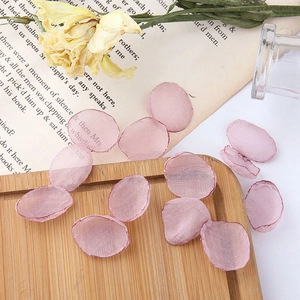 Close-up of translucent mauve mesh flower petals for DIY wedding jewelry making