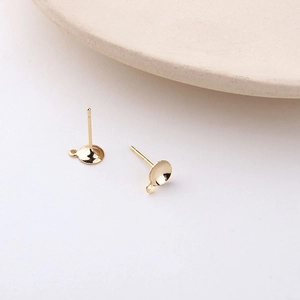 Close-up of gold-plated bowl earring posts with hanging loops for DIY jewelry making