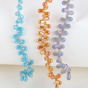 Macro detail of colorful aurora teardrop glass beads for DIY jewelry making and crafts