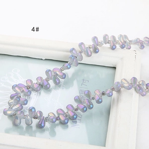 Macro view of iridescent aurora teardrop glass beads for DIY jewelry making