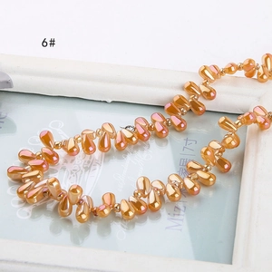 Macro shot of iridescent champagne orange teardrop glass beads for DIY jewelry making
