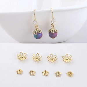 Detail of gold-plated flower bead caps and DIY earrings with purple crystals