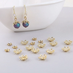 Macro detail of hollow gold-plated flower bead caps for DIY jewelry making and earrings