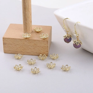 Macro detail of gold-plated filigree flower bead caps for DIY jewelry making