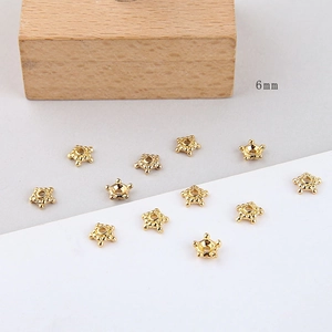 Detailed macro view of 6mm gold plated star shaped spacer beads for DIY jewelry making