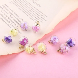 Handmade glass bubble pendants with dried flowers and gold metal caps for DIY jewelry