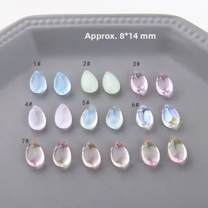 Macro detail of 8x14mm colorful teardrop crystal glass charms in seven vibrant shades