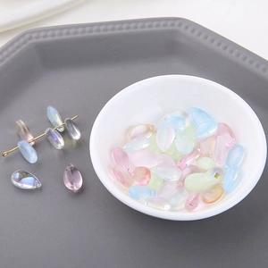 Macro shot of iridescent teardrop crystal beads in assorted pastel colors for DIY jewelry
