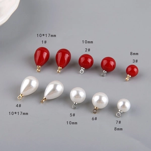 Detail of red and pearl white teardrop beads and spheres for DIY jewelry making