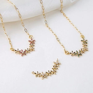 Detail of floral zircon pendants with pink and green crystals for DIY jewelry making