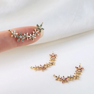 Macro detail of gold plated flower charms with colorful cubic zirconia for jewelry making