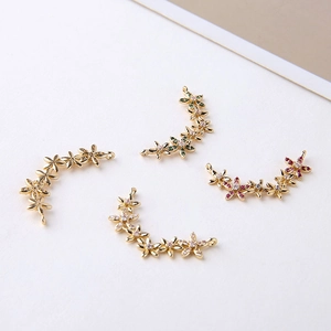 Macro shot of 14K gold-plated flower connector pendants with cubic zirconia for jewelry
