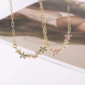 Close-up of gold-plated flower pendants with sparkling zircon inlays for DIY necklaces