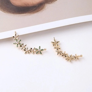 Macro detail of gold plated flower cluster pendant with white and green zircons