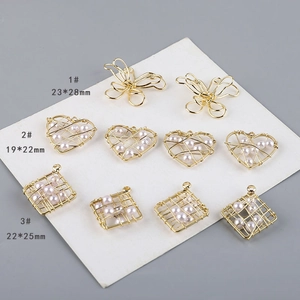 Detalle de colgantes de mariposa, corazón y cuadrado en hilo de oro 18K con perlas