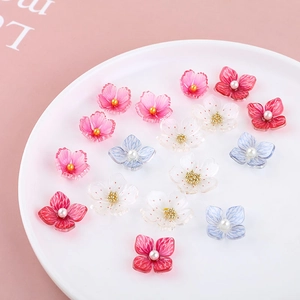 Detailed macro view of acrylic cherry blossom beads with pearl center for DIY jewelry