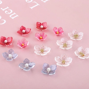 Macro detail of translucent acrylic cherry blossom beads with pearl and gold centers