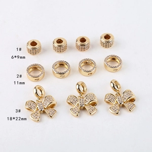 Detailed view of 14K gold plated brass charms with micro-pave cubic zirconia accents