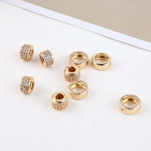 Macro view of 14K gold plated crystal pave cylinder and rondelle beads for jewelry making