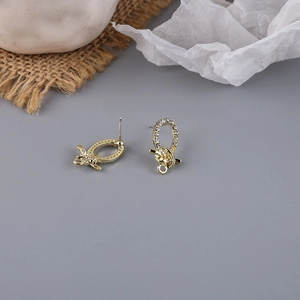 Macro detail of gold-plated alloy earring charms with rhinestones and DIY hanging loop