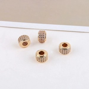 Macro detail of 14K gold plated bead charms with micro-pave cubic zirconia for jewelry DIY