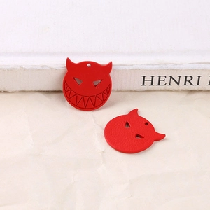 Detailed macro view of red matte alloy devil head charms for DIY jewelry and accessories