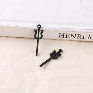 Close-up of black alloy trident pendants with matte finish for DIY jewelry making