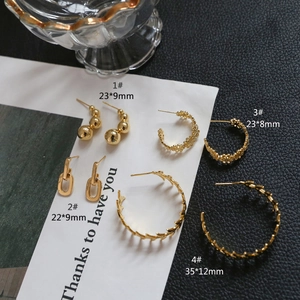 Detail view of four gold-plated floral C-shape hoop earrings and S925 silver studs