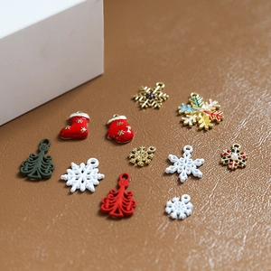 Close-up of Christmas alloy pendants with red socks, trees, and rhinestone snowflakes