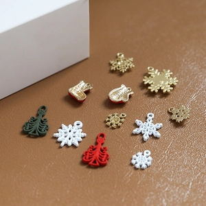 Macro shot of Christmas alloy charms with snowflake and tree designs for DIY crafts